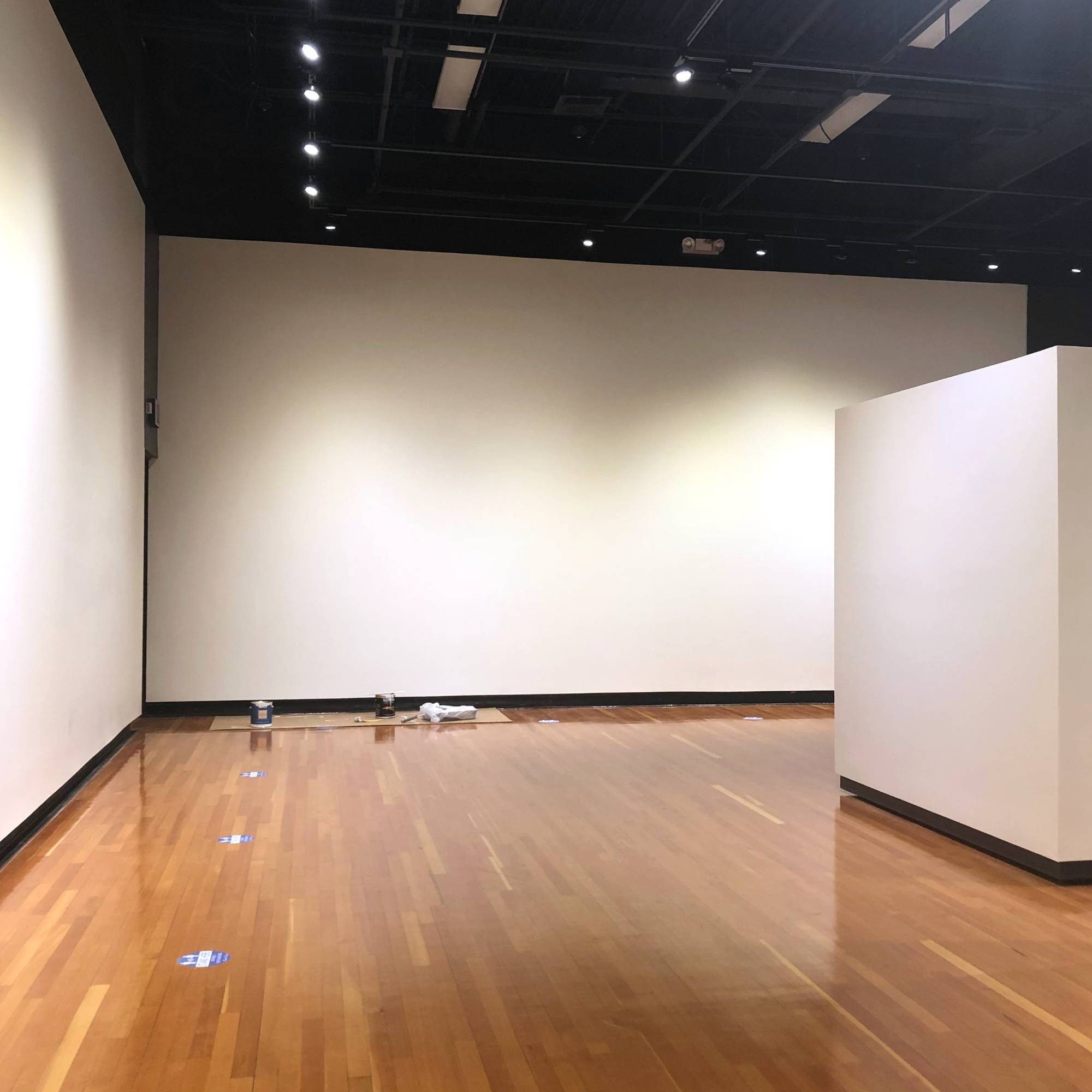 Photograph of an empty gallery with white walls